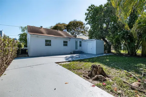 a front view of house with yard and trees