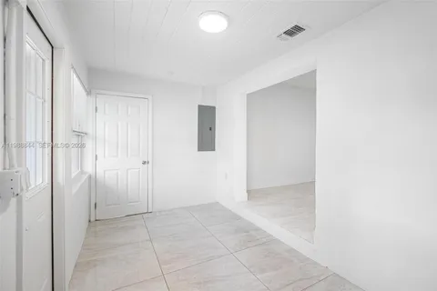 a kitchen with a refrigerator and a sink