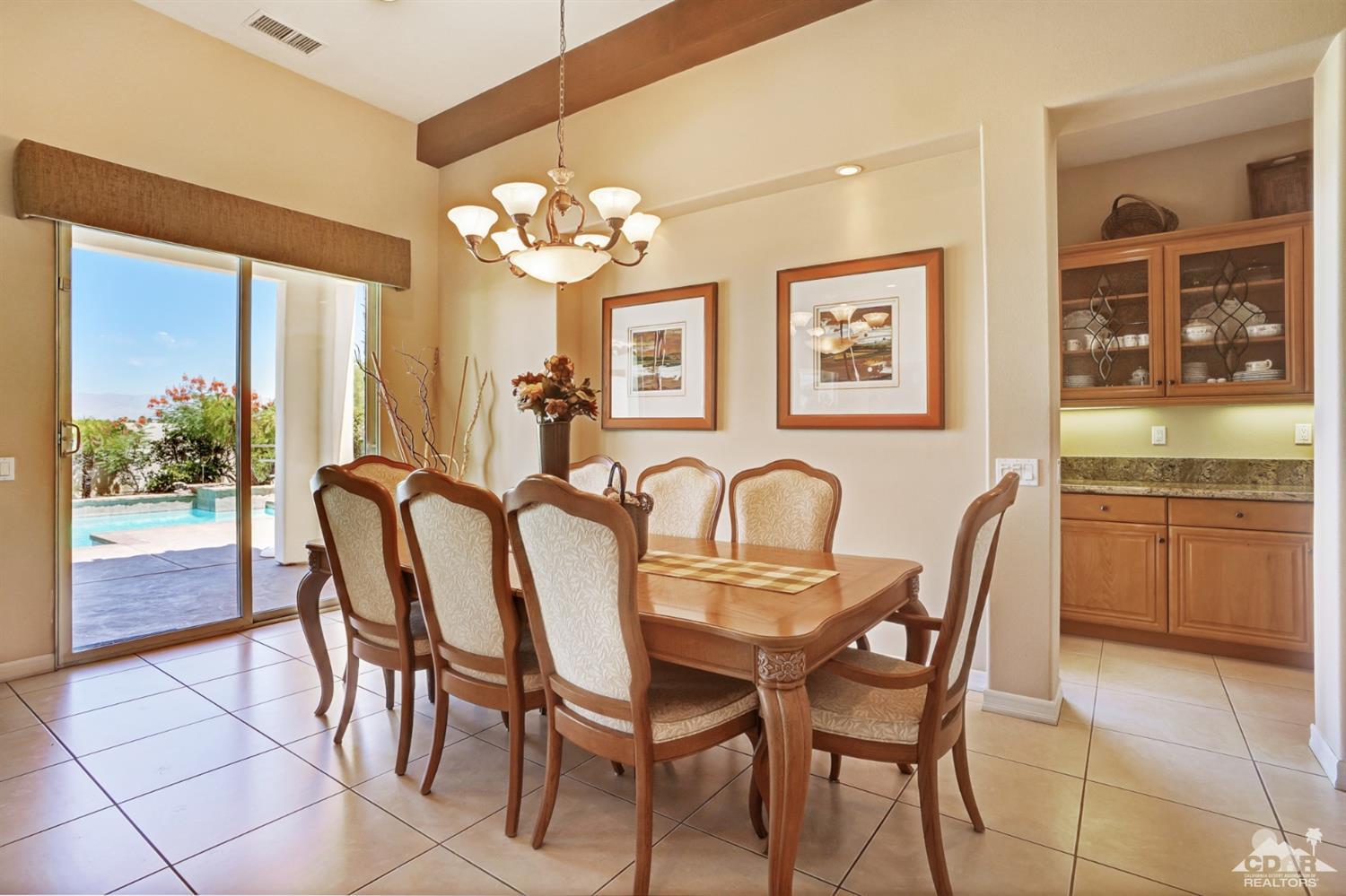 329 Loch Lomond Road Rancho Mirage, CA 92270 - Photo 11 of 50 a view of a dining room kitchen and a chandelier
