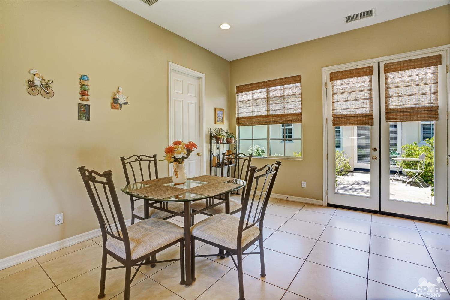 329 Loch Lomond Road Rancho Mirage, CA 92270 - Photo 18 of 50 a dining room with furniture and wooden floor