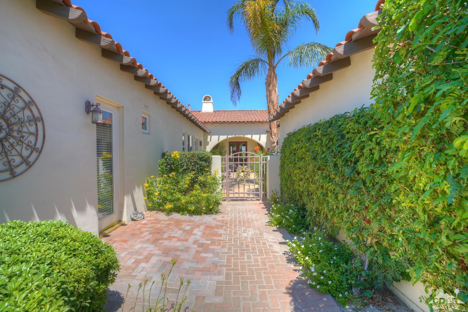 329 Loch Lomond Road Rancho Mirage, CA 92270 - Photo 3 of 50 a front view of a house with garden
