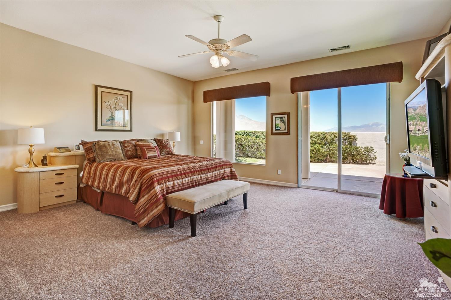 329 Loch Lomond Road Rancho Mirage, CA 92270 - Photo 22 of 50 a spacious bedroom with a bed and a large window