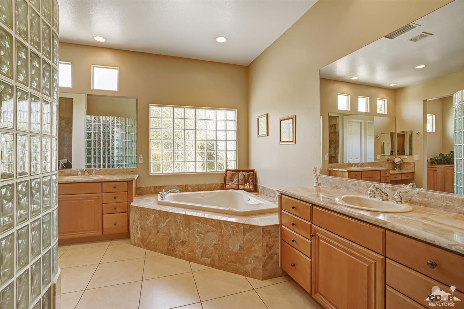 329 Loch Lomond Road Rancho Mirage, CA 92270 - Photo 24 of 50 a spacious bathroom with a granite countertop tub sink shower and mirror