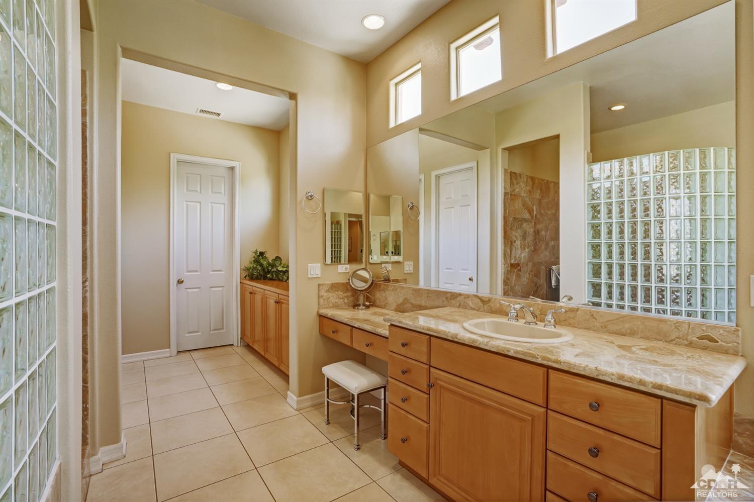 329 Loch Lomond Road Rancho Mirage, CA 92270 - Photo 25 of 50 a spacious bathroom with a granite countertop sink mirror and a