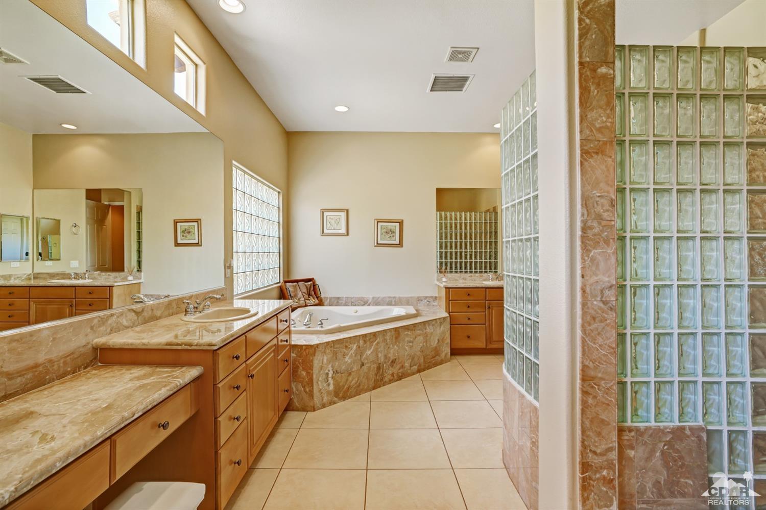 329 Loch Lomond Road Rancho Mirage, CA 92270 - Photo 26 of 50 a spacious bathroom with a tub sink and mirror