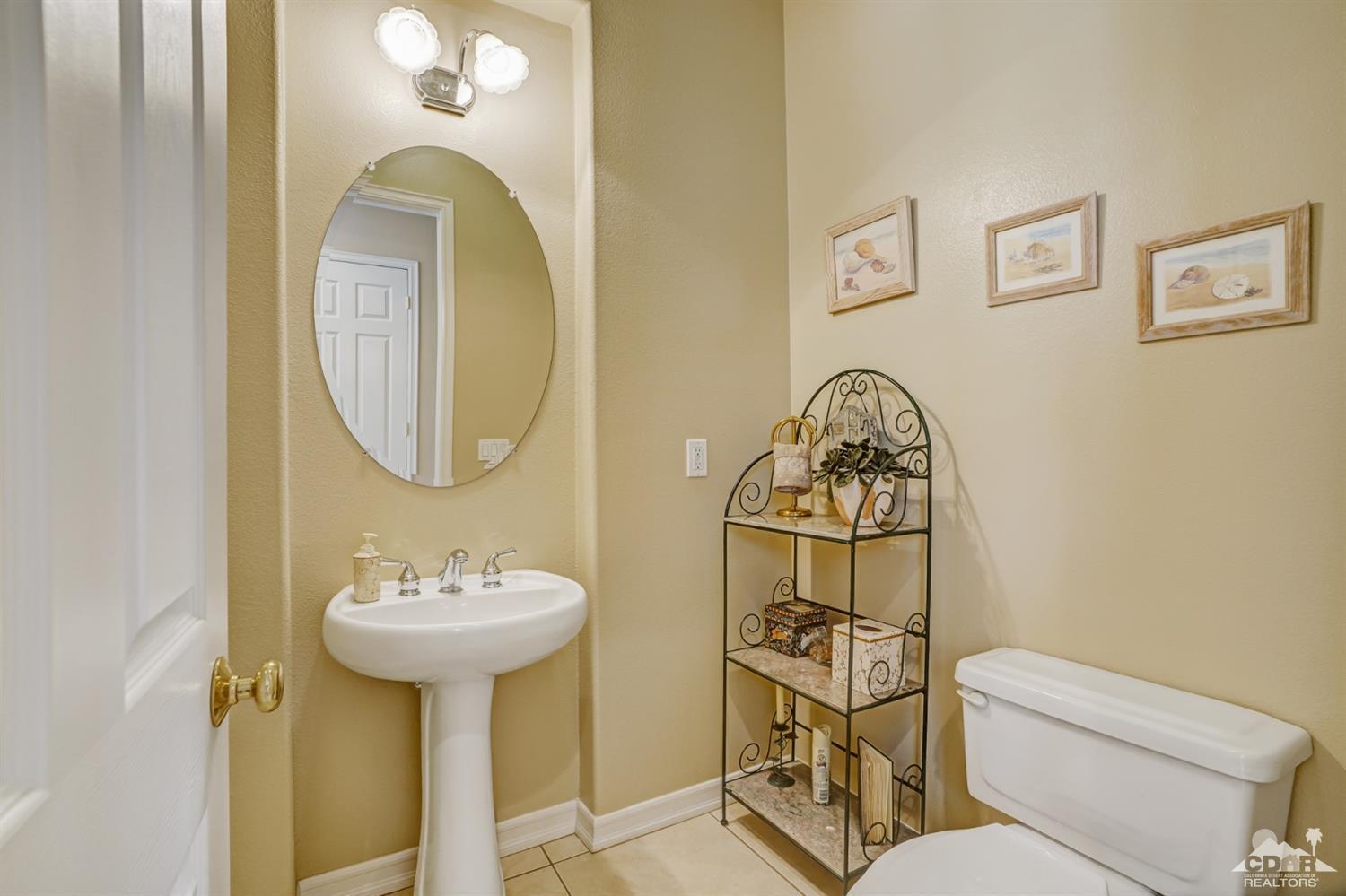 329 Loch Lomond Road Rancho Mirage, CA 92270 - Photo 27 of 50 a bathroom with a toilet sink and mirror