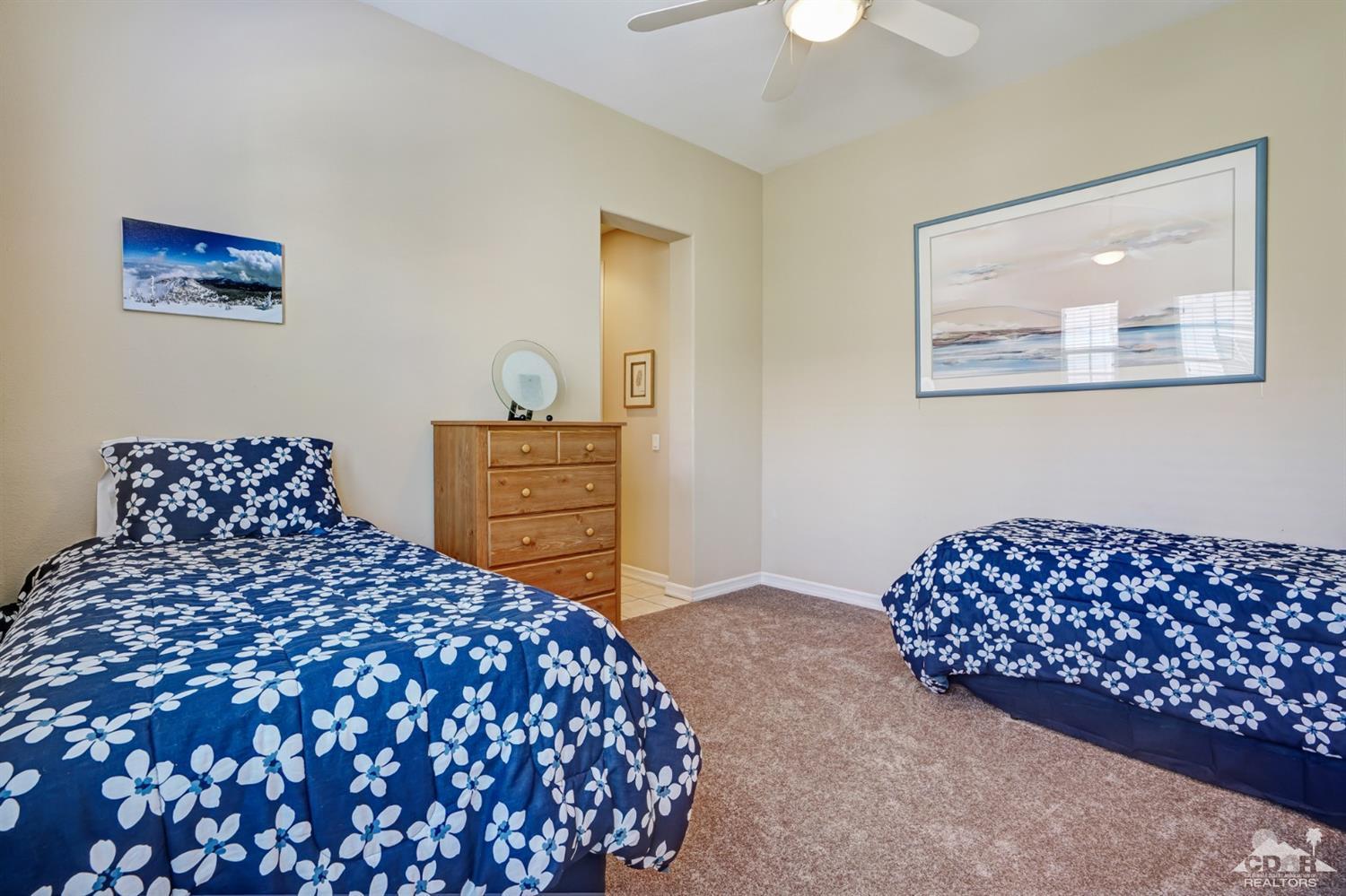329 Loch Lomond Road Rancho Mirage, CA 92270 - Photo 28 of 50 a bedroom with a bed and a lamp on dresser