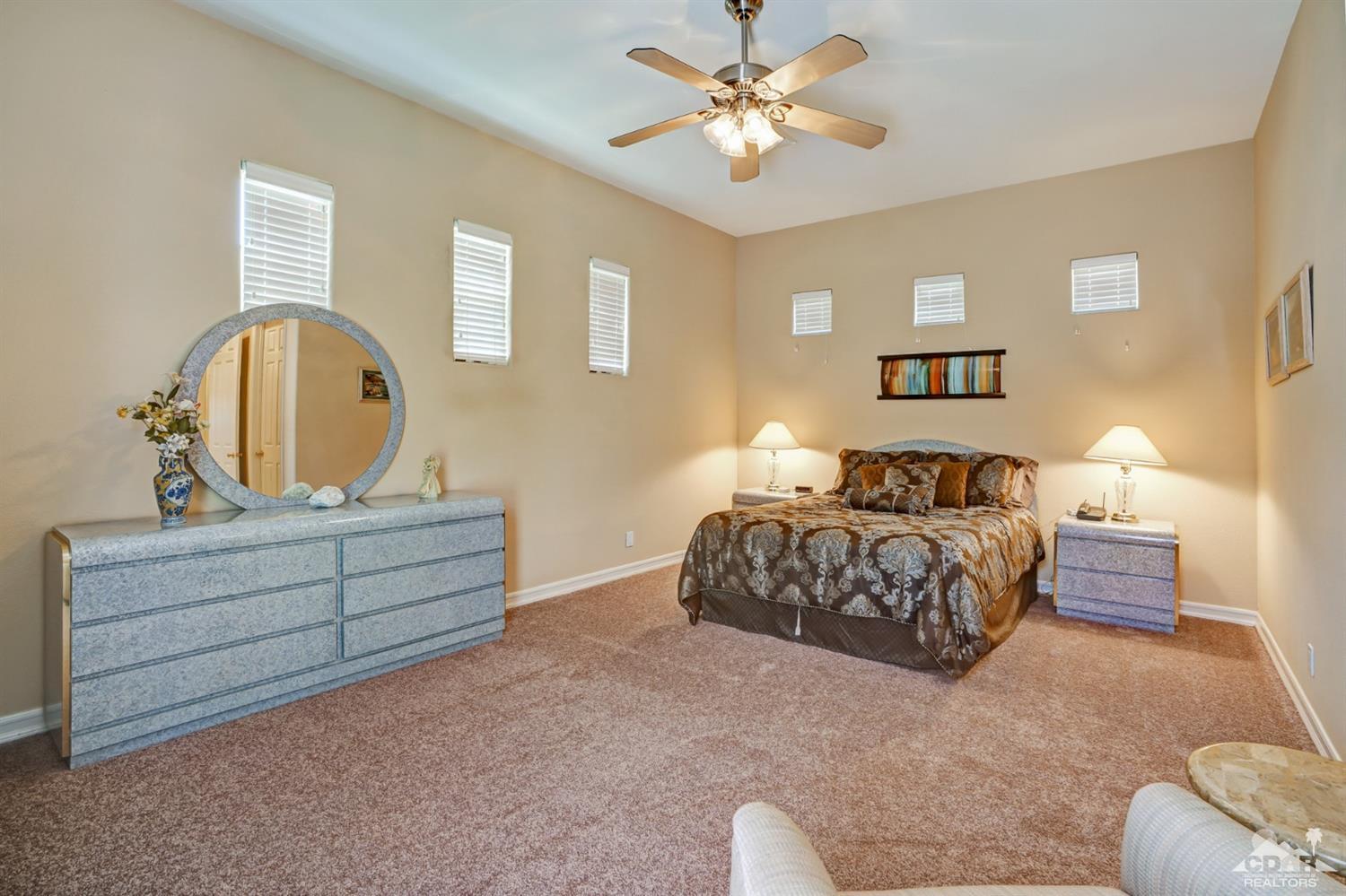 329 Loch Lomond Road Rancho Mirage, CA 92270 - Photo 30 of 50 a bedroom with a bed and a chandelier
