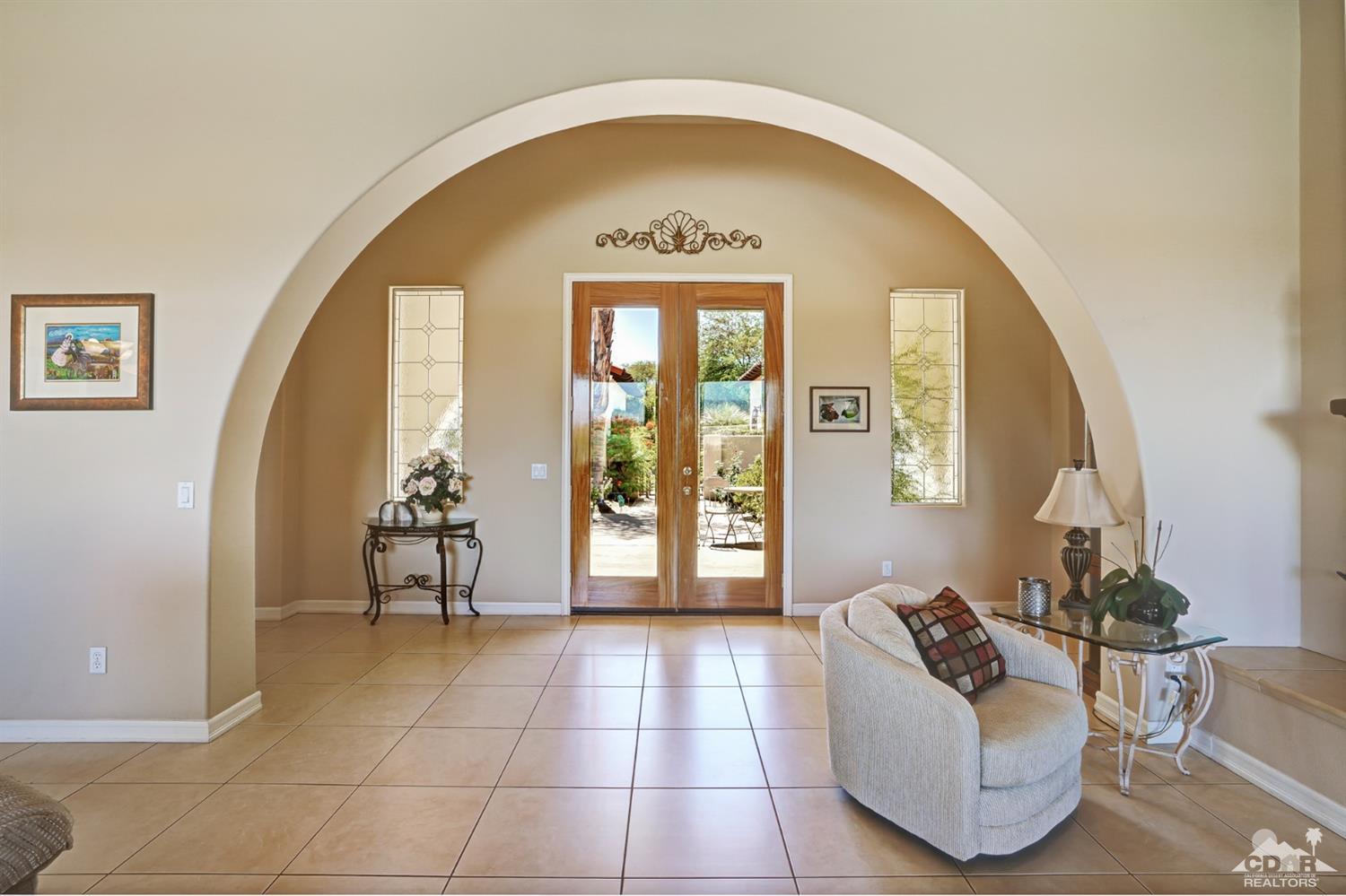329 Loch Lomond Road Rancho Mirage, CA 92270 - Photo 6 of 50 a living room with furniture and a large window