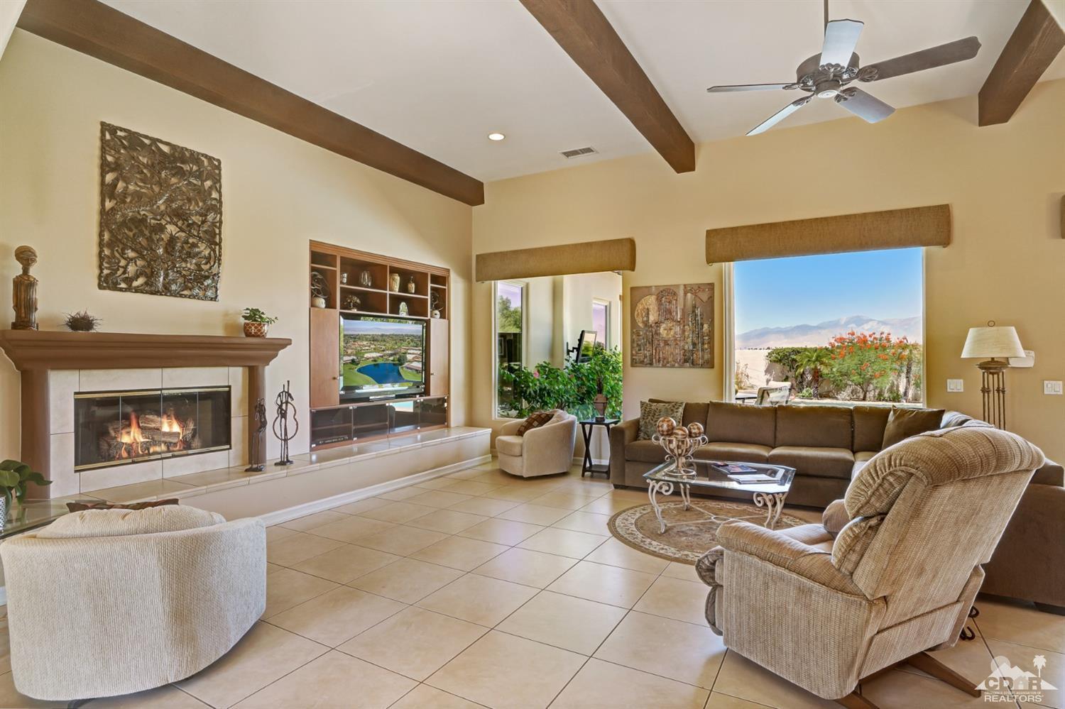 329 Loch Lomond Road Rancho Mirage, CA 92270 - Photo 8 of 50 a living room with furniture potted plant fireplace and a large window