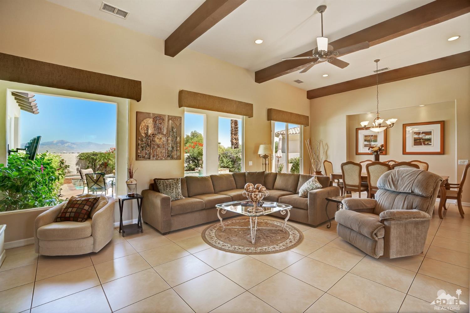 329 Loch Lomond Road Rancho Mirage, CA 92270 - Photo 9 of 50 a living room with furniture potted plant and a large window