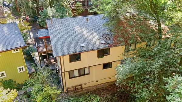 an aerial view of a house with a yard