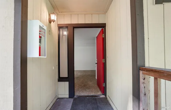 a view of empty room with a kitchen