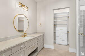 1141 East Lost Ridge Drive Washington, UT 84780 - Photo 98 of 108 Vanity with built-in cabinetry, an undermount sink, and a circular mirror