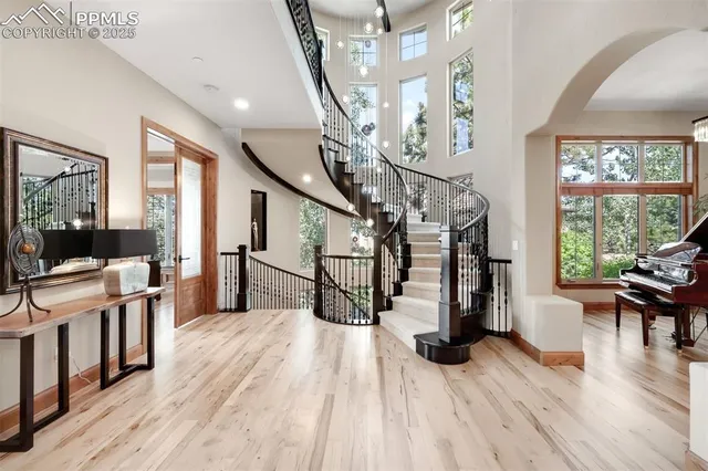 a view of entryway and hall with wooden floor