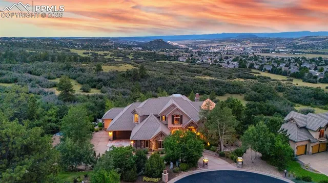 an aerial view of house with yard and mountain view in back