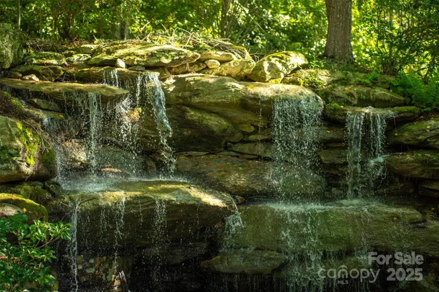 a view of residential houses with outdoor space and trees