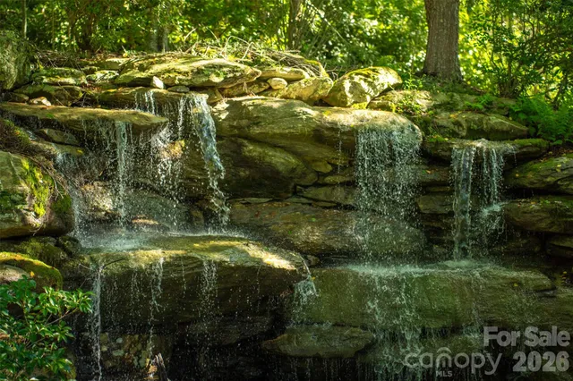 a view of residential houses with outdoor space and trees