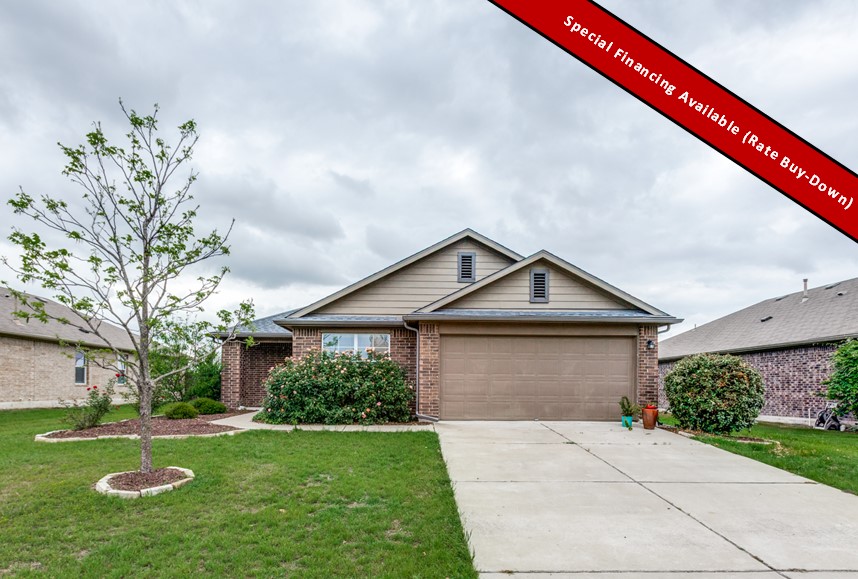 This property features a brick exterior with complementary siding, a two-car garage, and an inviting walkway leading to the entrance