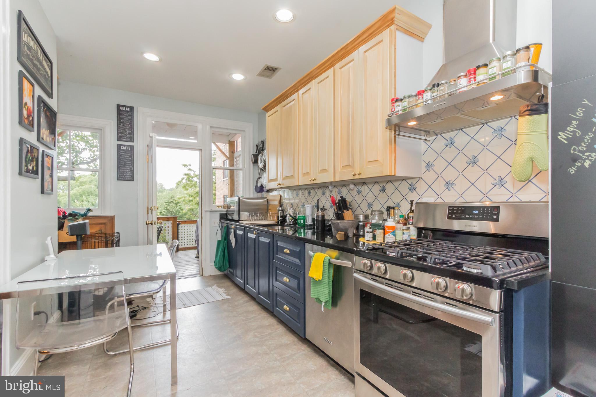 3150 19th Street Northwest Washington, DC 20010 - Photo 14 of 30 a kitchen with stainless steel appliances granite countertop a stove a sink dishwasher and cabinets with wooden floor
