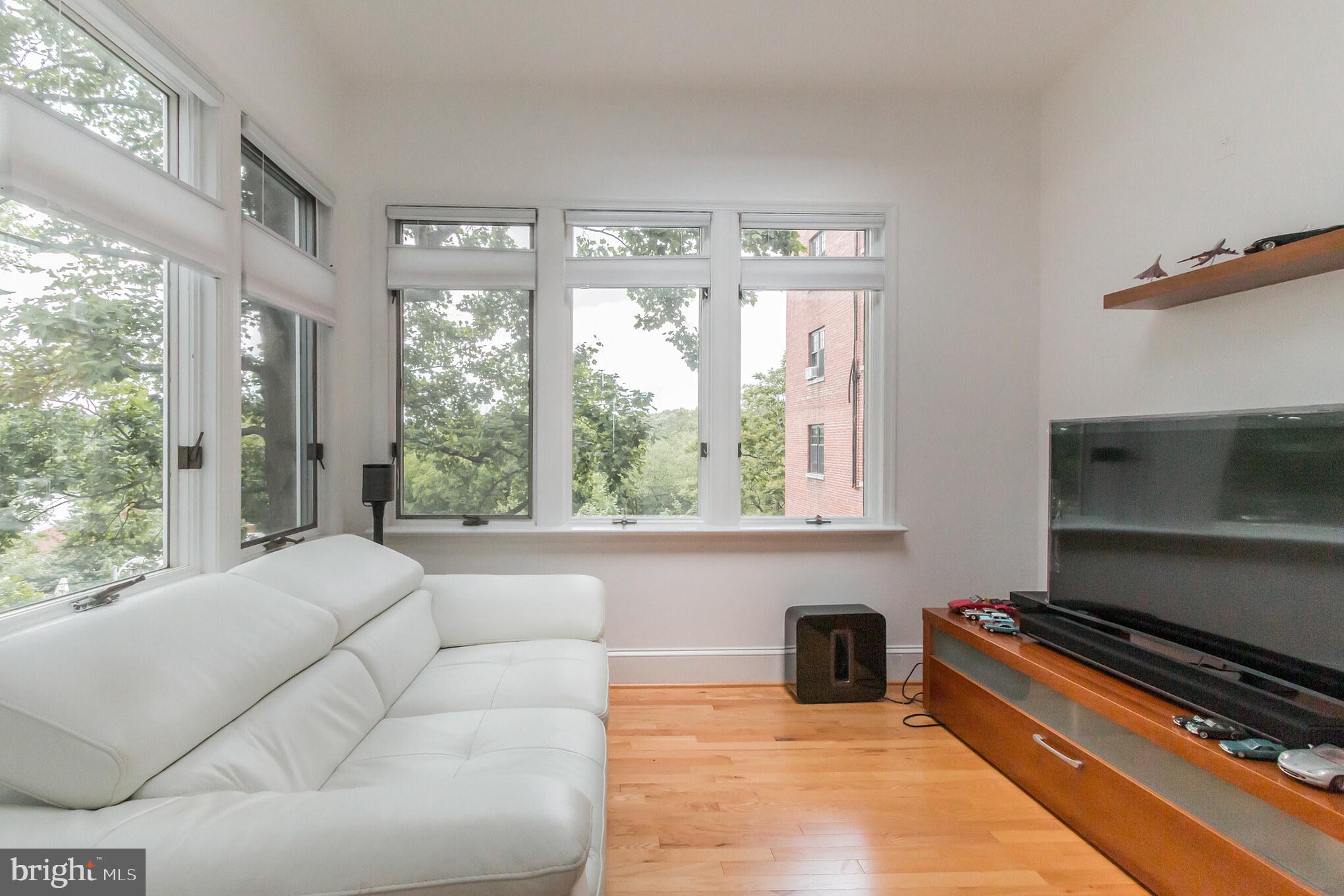 3150 19th Street Northwest Washington, DC 20010 - Photo 18 of 30 a living room with furniture and a floor to ceiling window