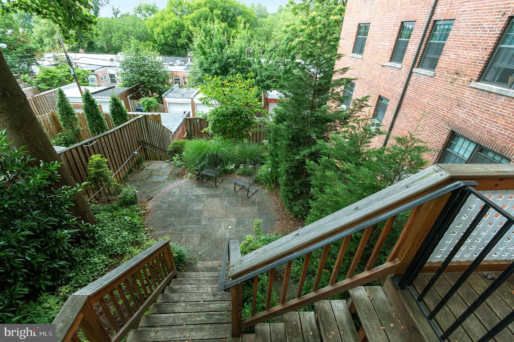 3150 19th Street Northwest Washington, DC 20010 - Photo 26 of 30 a balcony with wooden floor and trees in the back