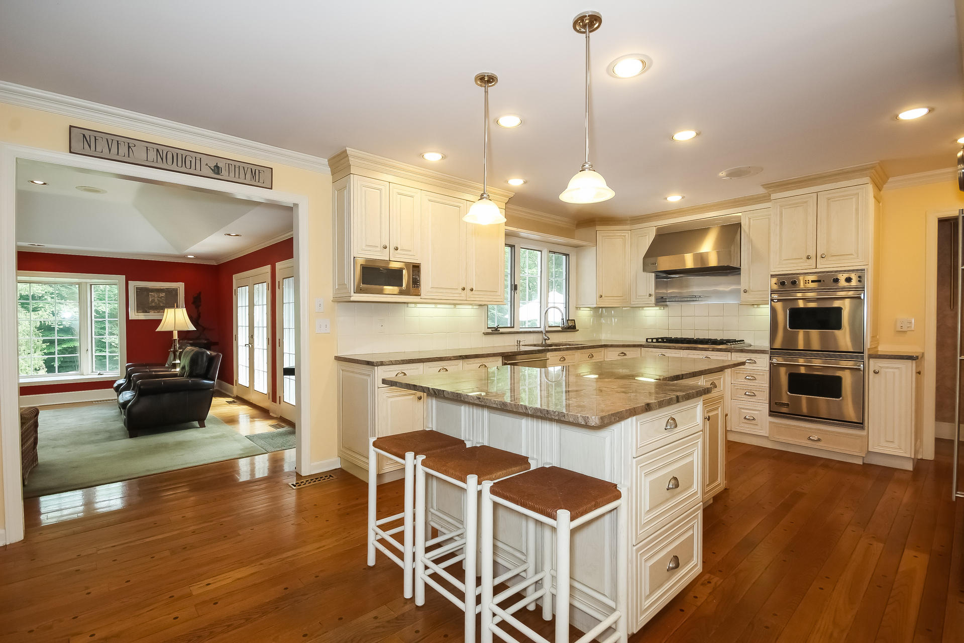 447 Valley Road New Canaan, CT 06840 - Photo 13 of 49 a kitchen with stainless steel appliances kitchen island granite countertop a stove a sink and a wooden floors