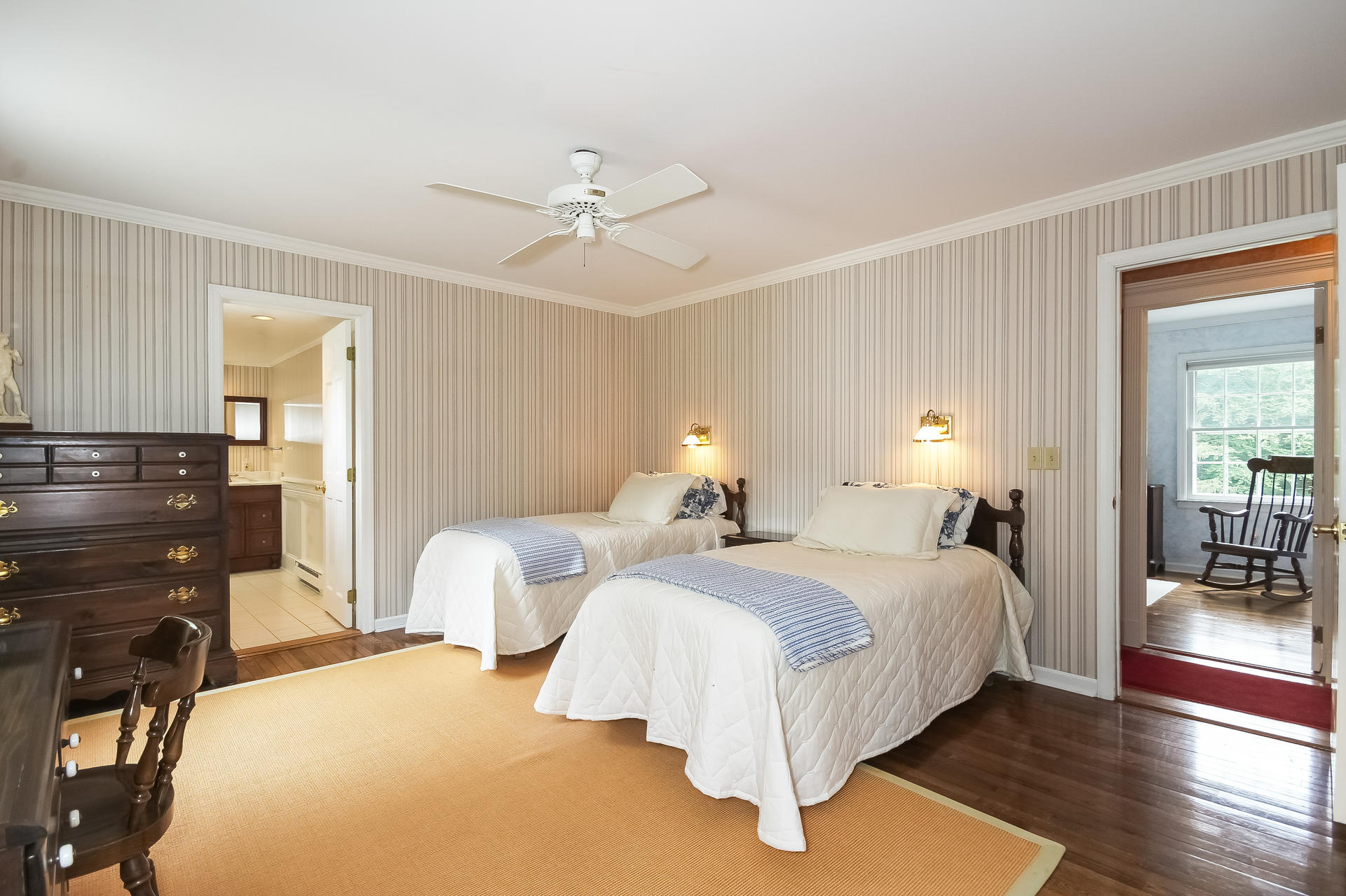 447 Valley Road New Canaan, CT 06840 - Photo 26 of 49 a bedroom with two beds and a chandelier