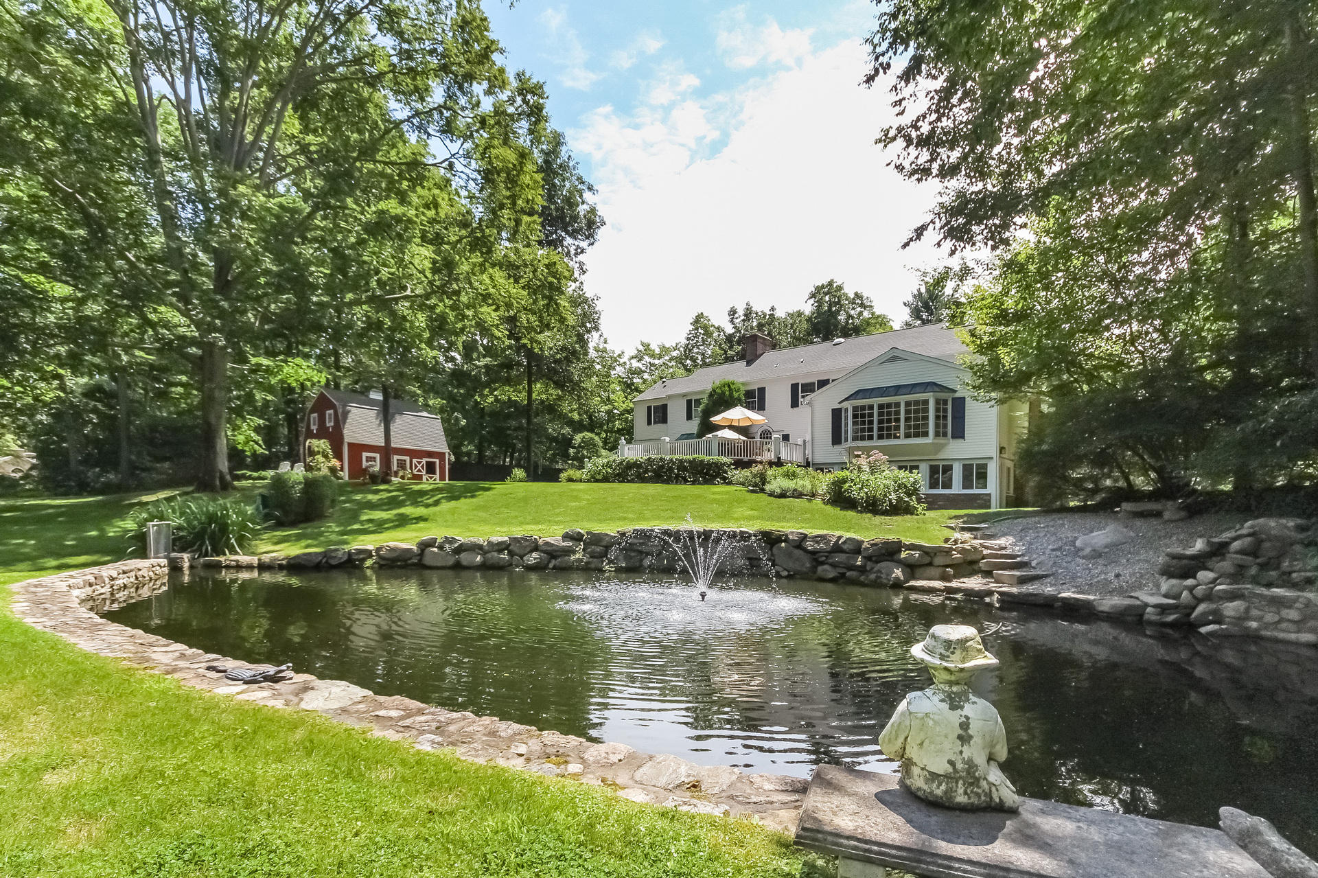 447 Valley Road New Canaan, CT 06840 - Photo 36 of 49 a house with river in front of it