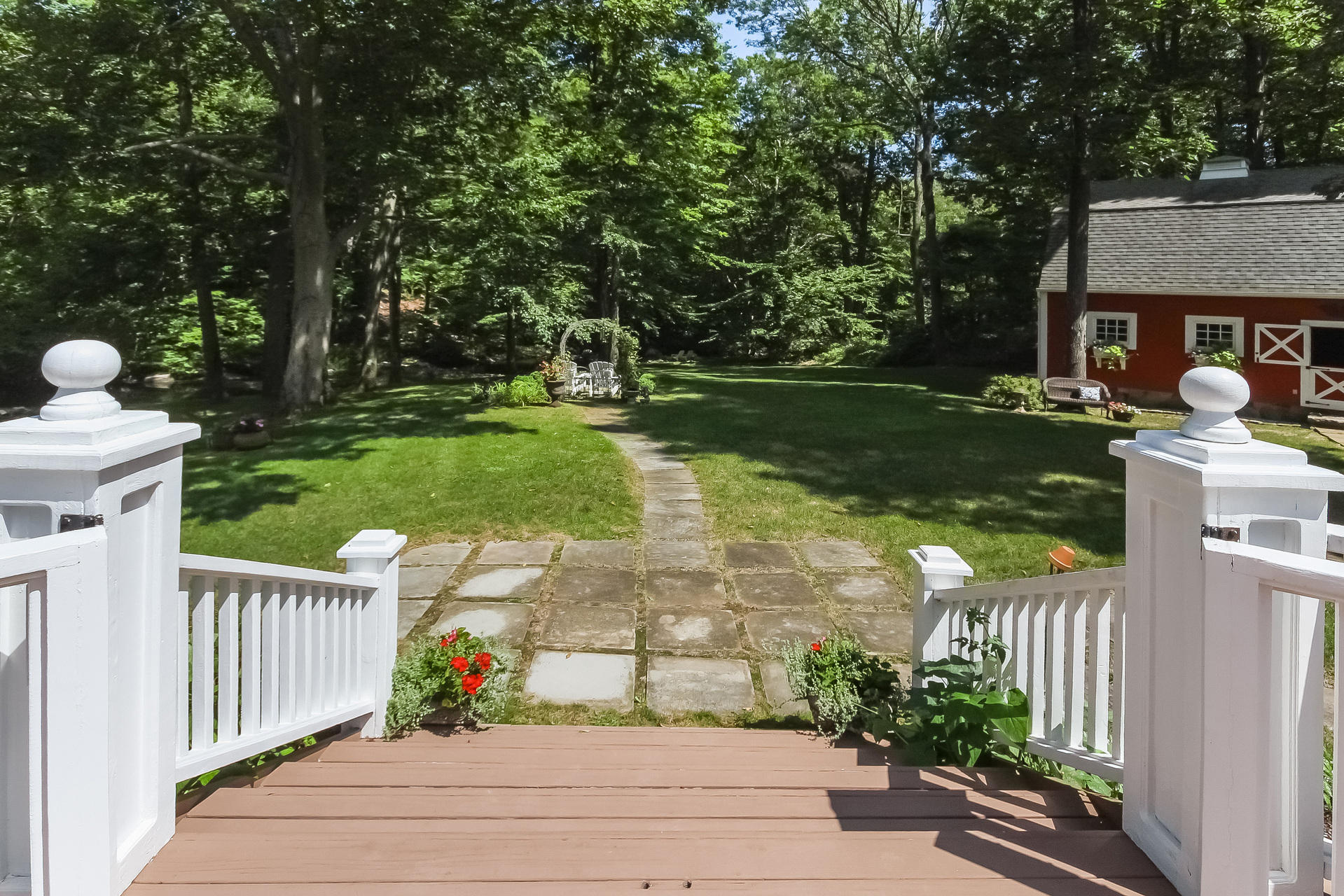 447 Valley Road New Canaan, CT 06840 - Photo 41 of 49 a view of a entrance front of house with a yard