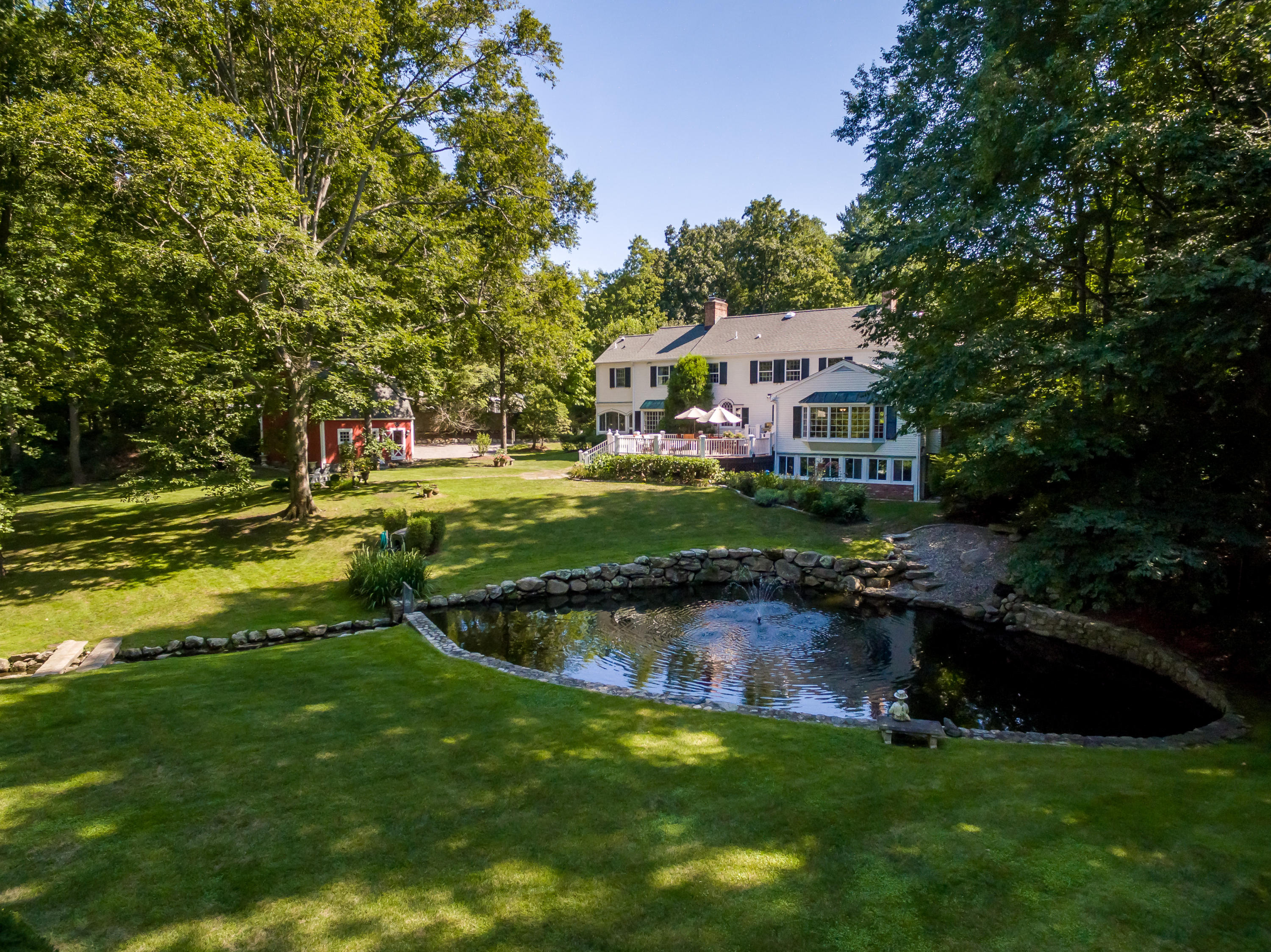 447 Valley Road New Canaan, CT 06840 - Photo 44 of 49 a view of a house with a big yard
