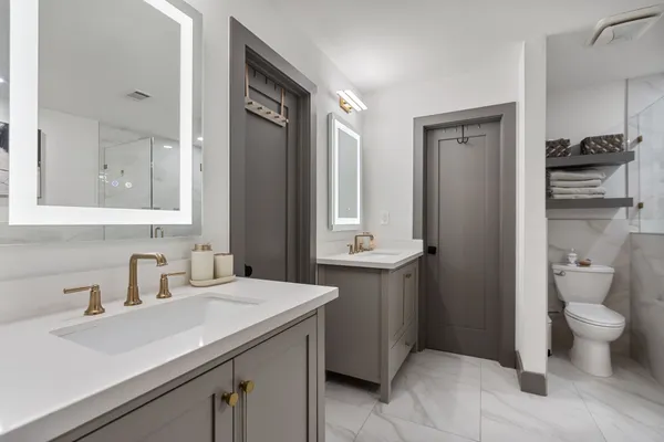 a bathroom with a sink toilet and shower