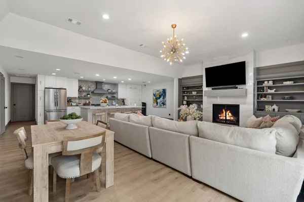 a living room with furniture a flat screen tv and a fireplace