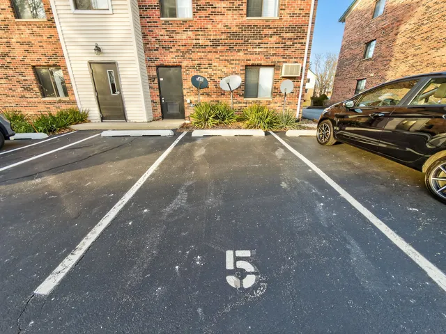 a view of a car parked on the side of a street