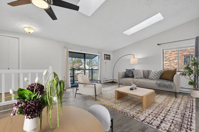 a living room with furniture and a potted plant