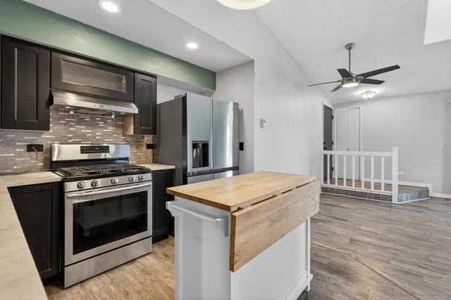 a kitchen with a stove and a refrigerator