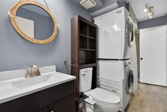 a bathroom with a toilet a sink and a mirror