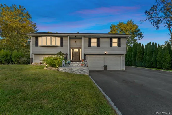 a front view of a house with a garden and yard