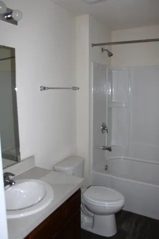 a bathroom with a sink toilet vanity and shower