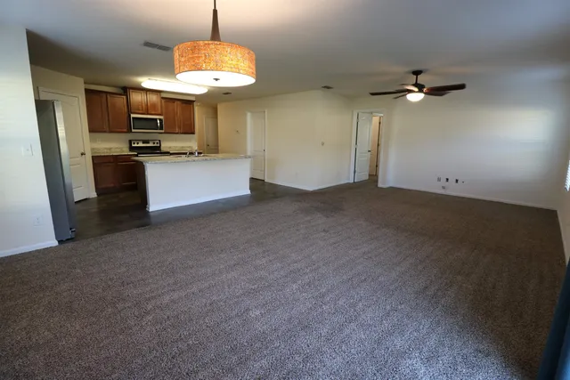 a view of kitchen with sink microwave and refrigerator