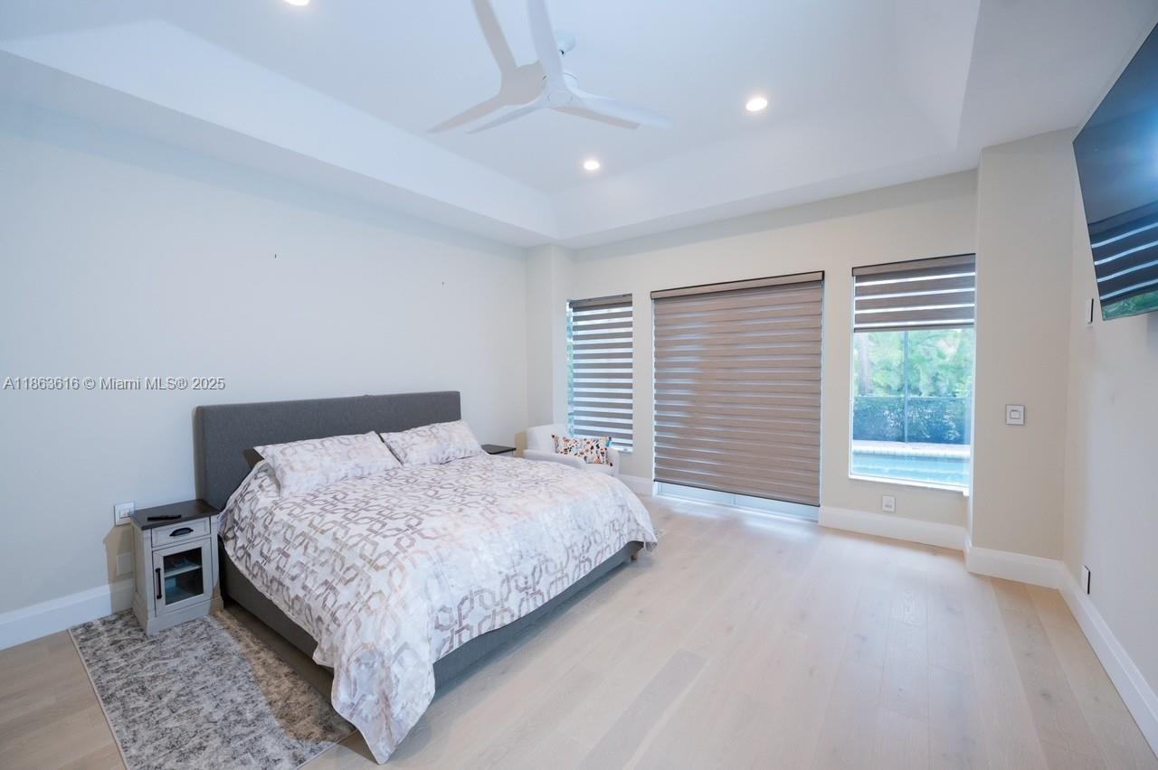 17969 Fairoaks Way Boca Raton, FL 33498 - Photo 11 of 24 a bedroom with a bed and a large window