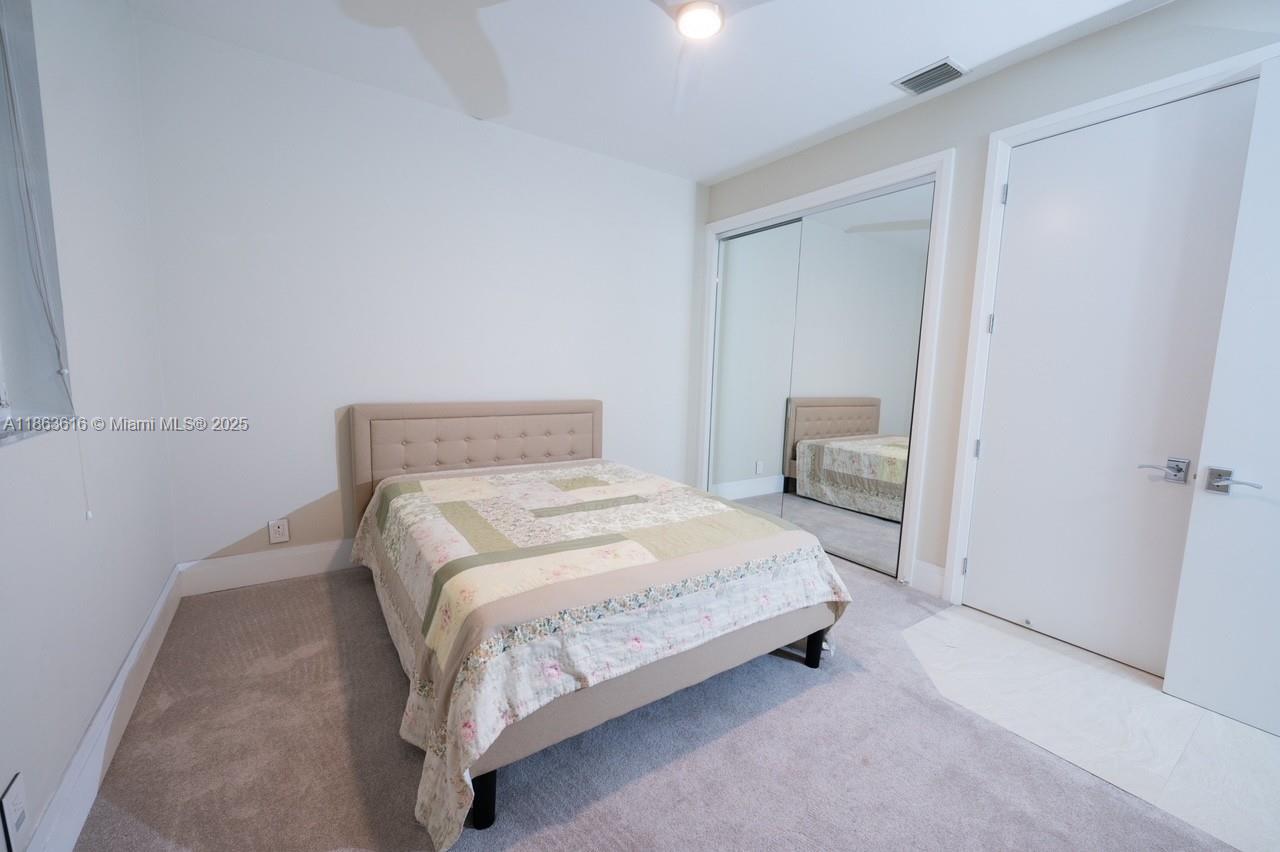 17969 Fairoaks Way Boca Raton, FL 33498 - Photo 13 of 24 a bedroom with a bed and chair