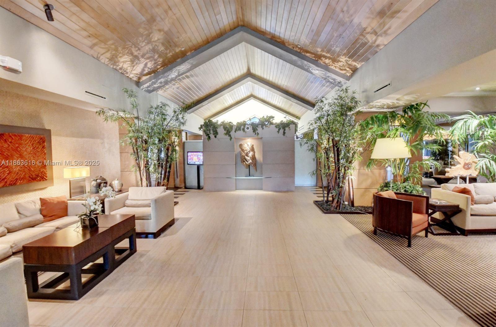 17969 Fairoaks Way Boca Raton, FL 33498 - Photo 23 of 24 a living room with furniture and a chandelier