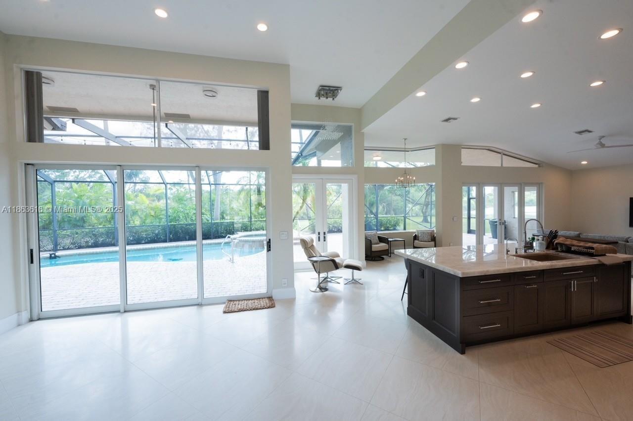 17969 Fairoaks Way Boca Raton, FL 33498 - Photo 6 of 24 a living room with furniture and a large window