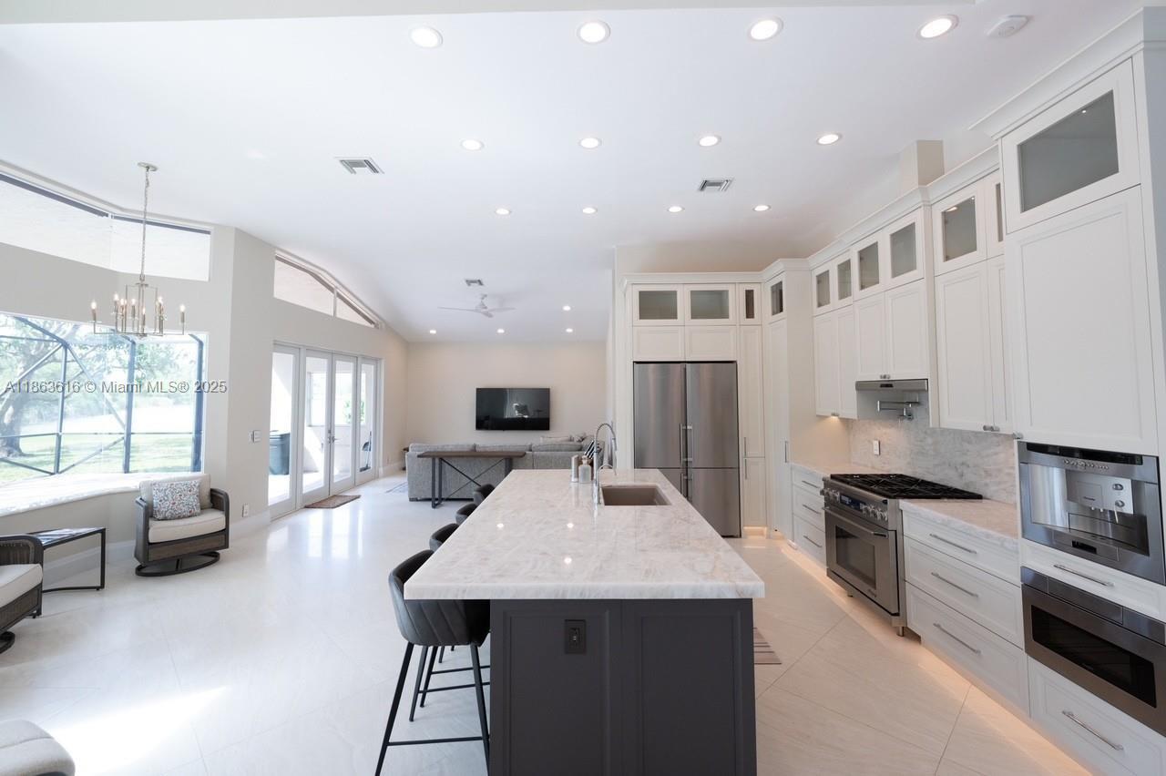 17969 Fairoaks Way Boca Raton, FL 33498 - Photo 7 of 24 a kitchen with sink refrigerator and stove