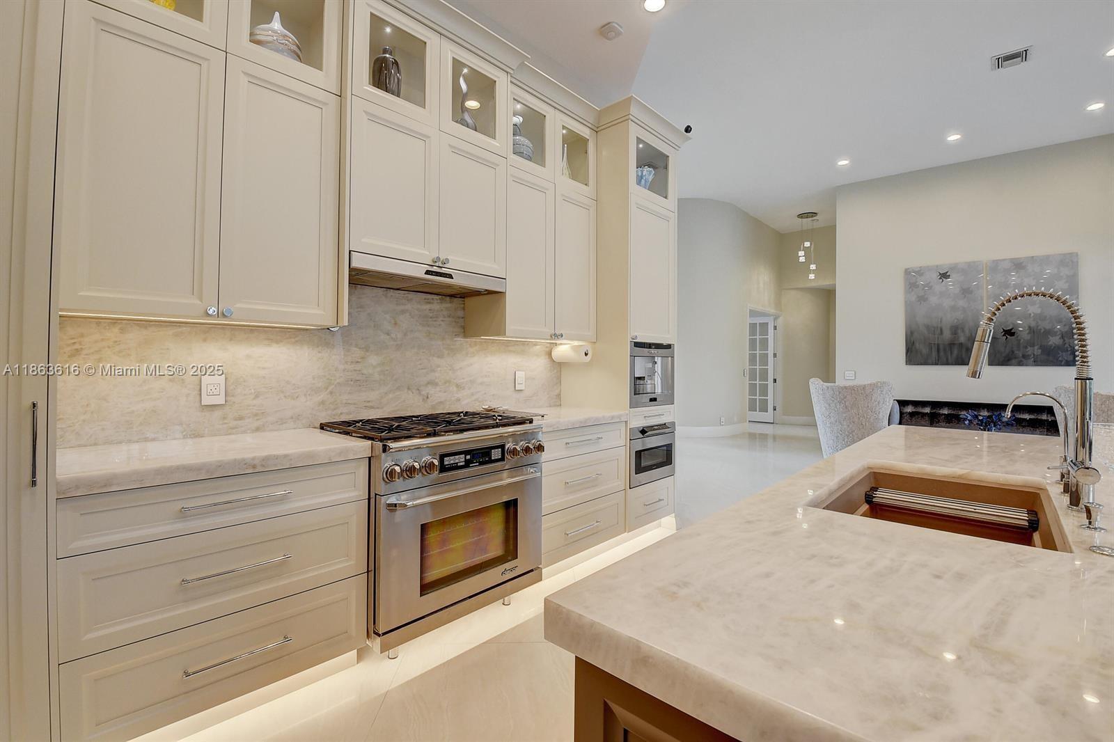 17969 Fairoaks Way Boca Raton, FL 33498 - Photo 8 of 24 a kitchen with granite countertop a stove and a sink