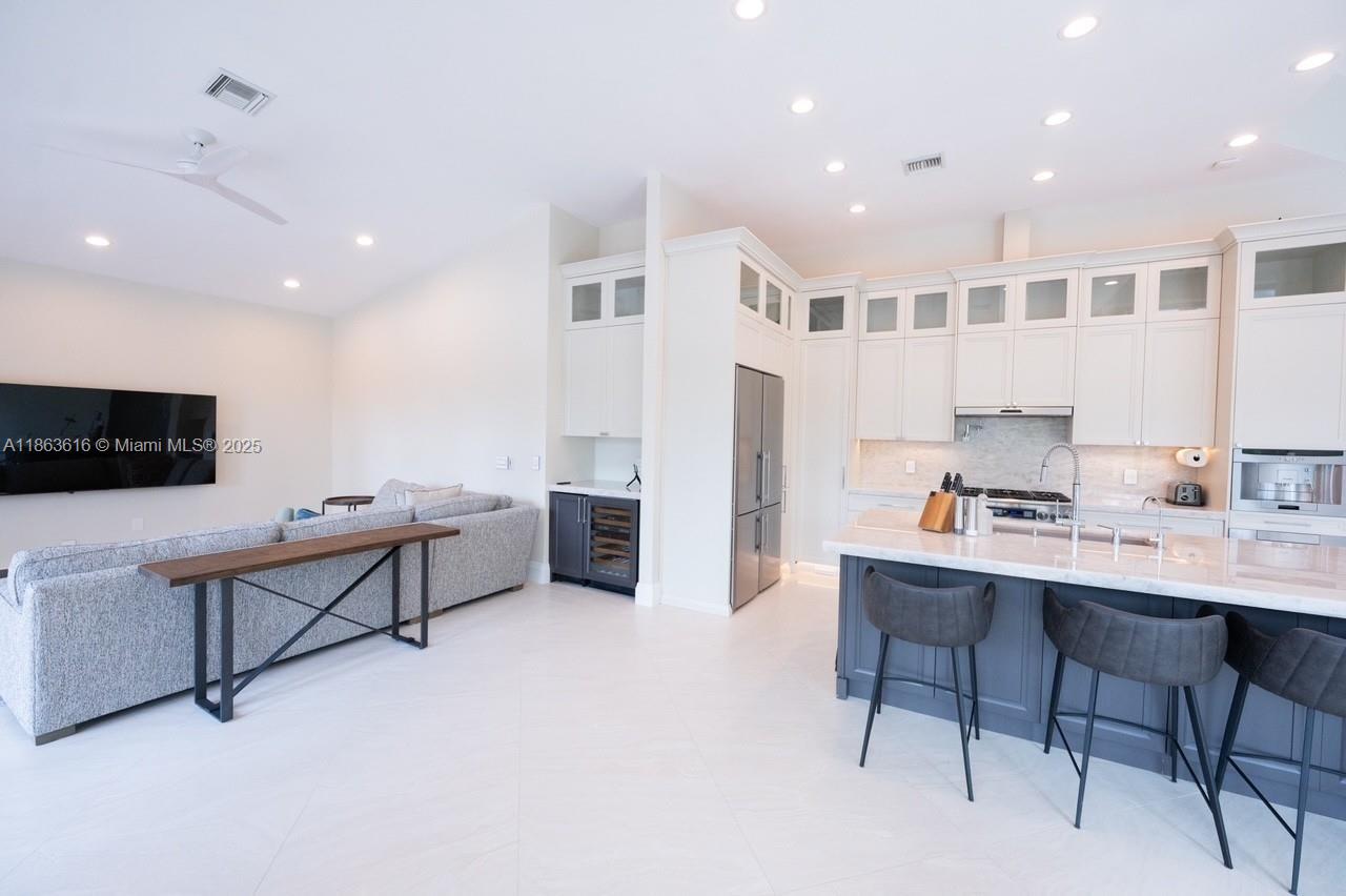 17969 Fairoaks Way Boca Raton, FL 33498 - Photo 9 of 24 a living room with furniture and a flat screen tv
