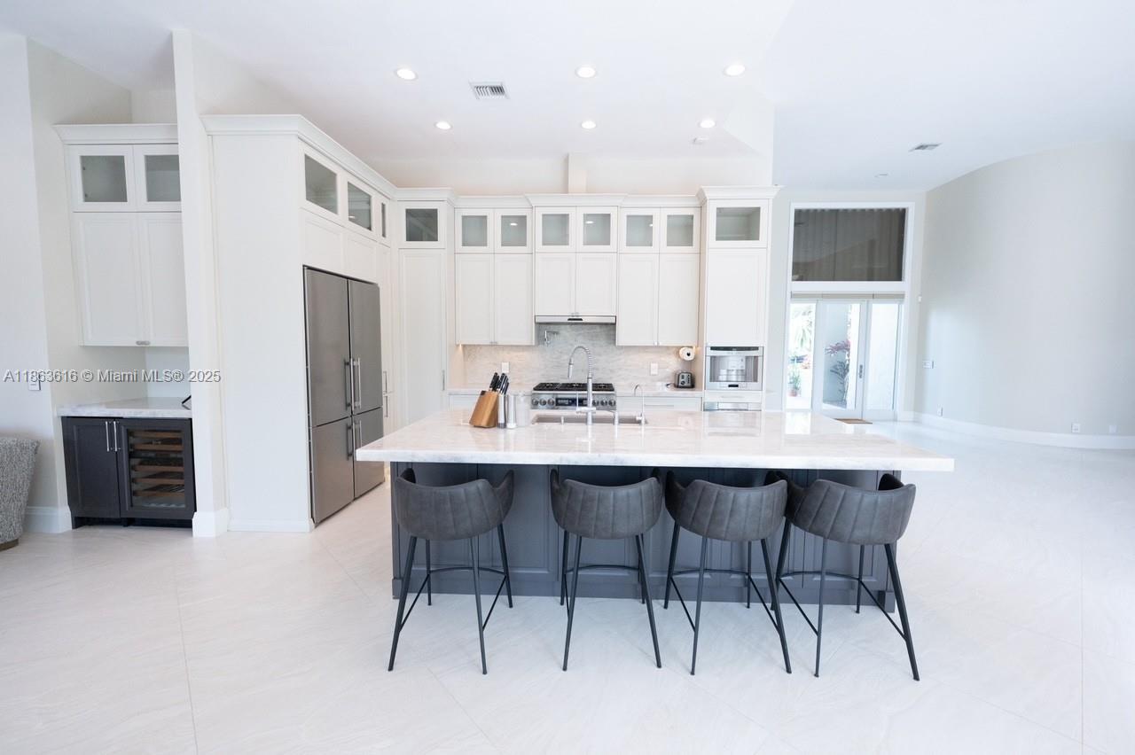 17969 Fairoaks Way Boca Raton, FL 33498 - Photo 10 of 24 a kitchen with a dining table chairs and refrigerator