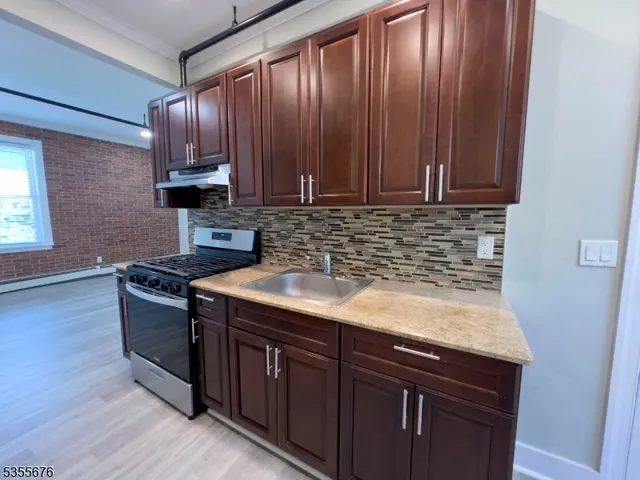a kitchen with a sink stove and cabinets