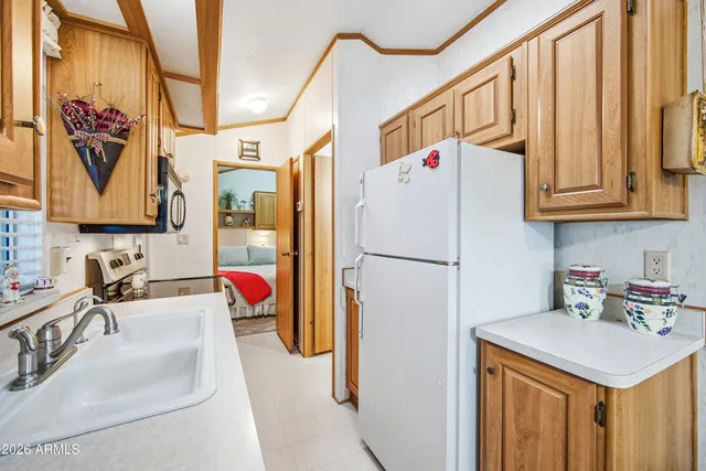 a kitchen with stainless steel appliances granite countertop a sink and a refrigerator